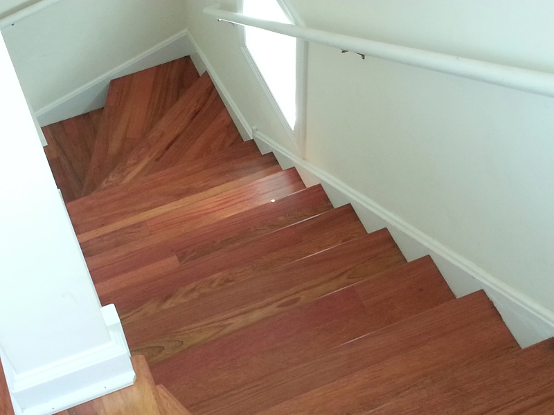 Brazilian Cherry hardwood staircase with matching wood treads and landing in Lake Forest, IL by Midwest Hardwood Floors