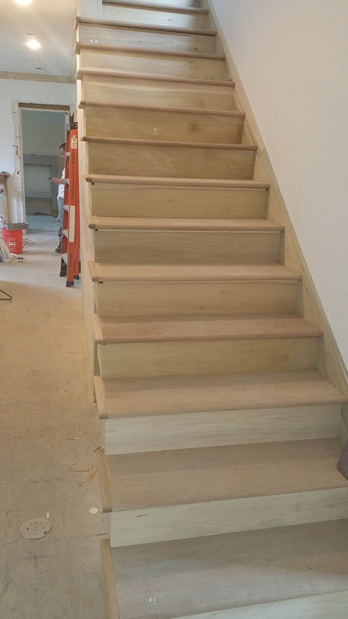New hardwood staircase installation with oak treads and risers in a Chicago home