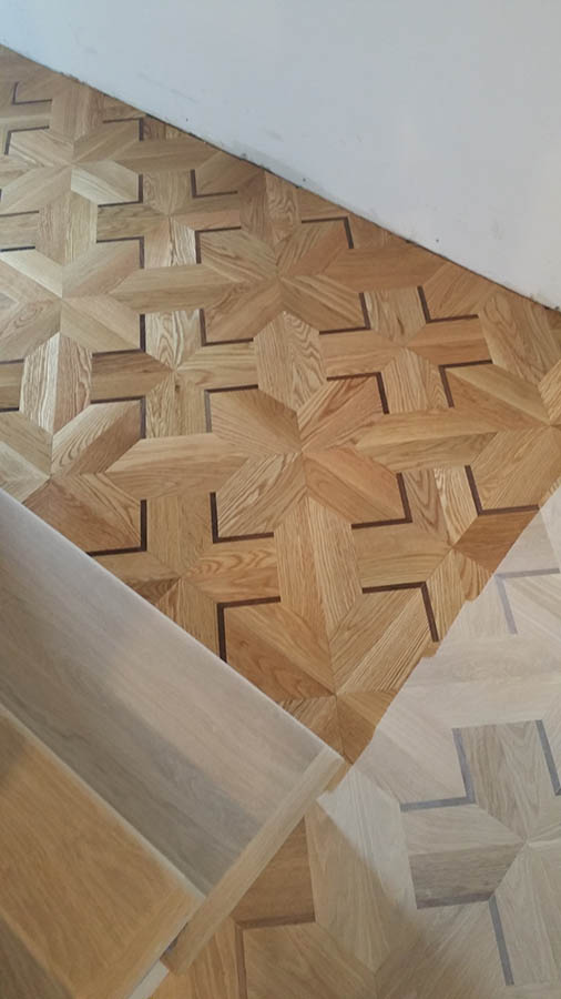 Custom white oak and Wenge hardwood floor pattern with white oak stairs in Chicago, IL by Midwest Hardwood Floors