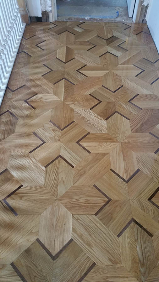 Custom white oak geometric hardwood floor pattern with Wenge inlays in Chicago, IL by Midwest Hardwood Floors