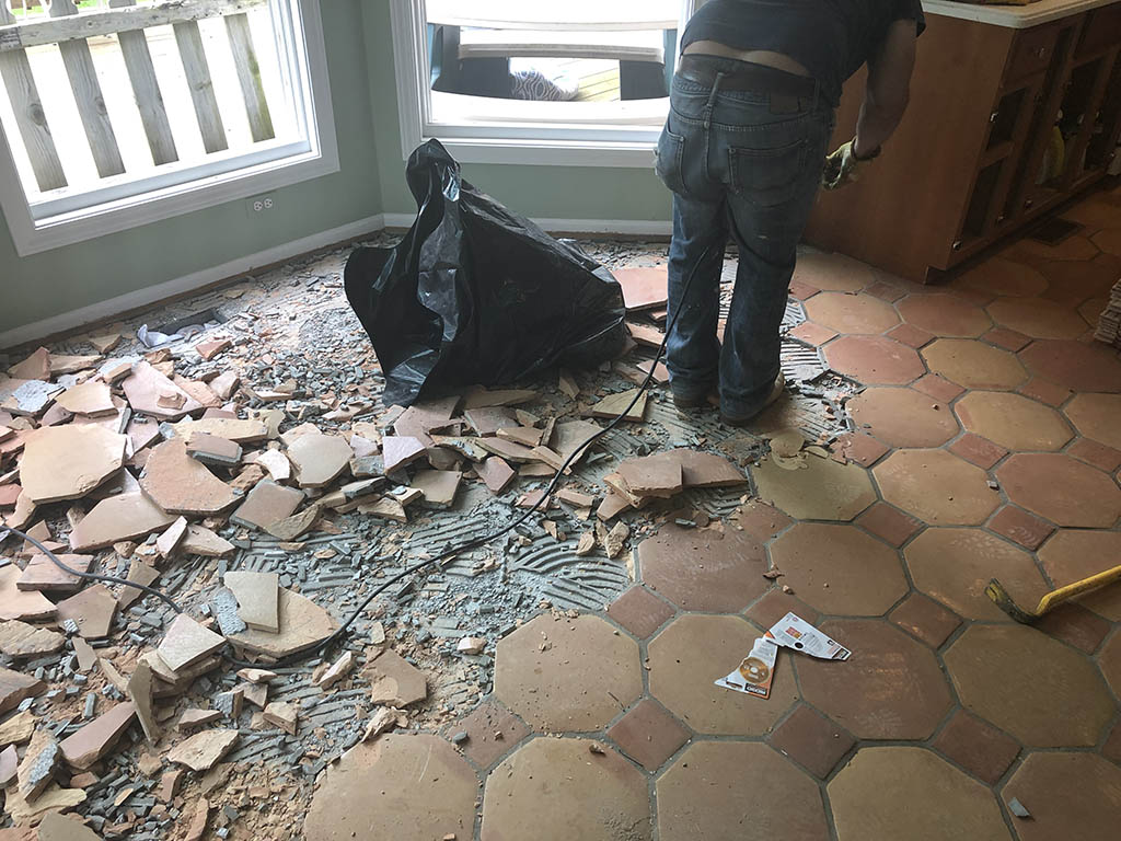 Ceramic tile flooring being removed for new hardwood installation in Morton Grove, IL by Midwest Hardwood Floors