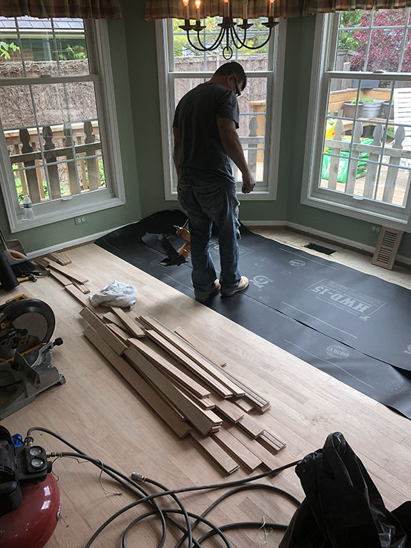 New hardwood flooring being installed over prepared underlayment in Morton Grove, IL by Midwest Hardwood Floors