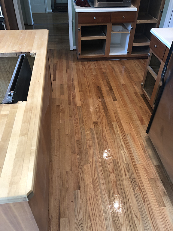 Finished hardwood flooring after tile replacement in Morton Grove, IL by Midwest Hardwood Floors