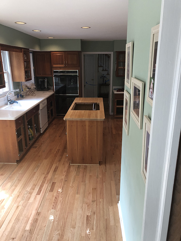 Completed hardwood kitchen flooring after ceramic tile replacement in Morton Grove, IL by Midwest Hardwood Floors