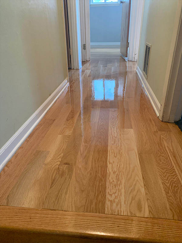 Finished white oak hardwood flooring in hallway by Midwest Hardwood Floors