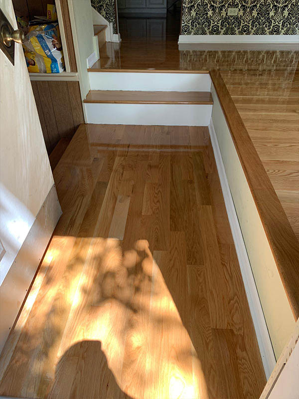 White oak hardwood floor and stair landing installation by Midwest Hardwood Floors