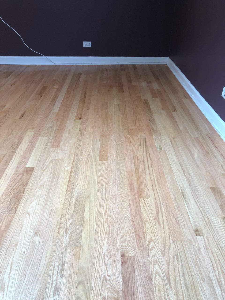 Red oak bedroom floor sanded and prepared for Classic Gray stain by Midwest Hardwood Floors