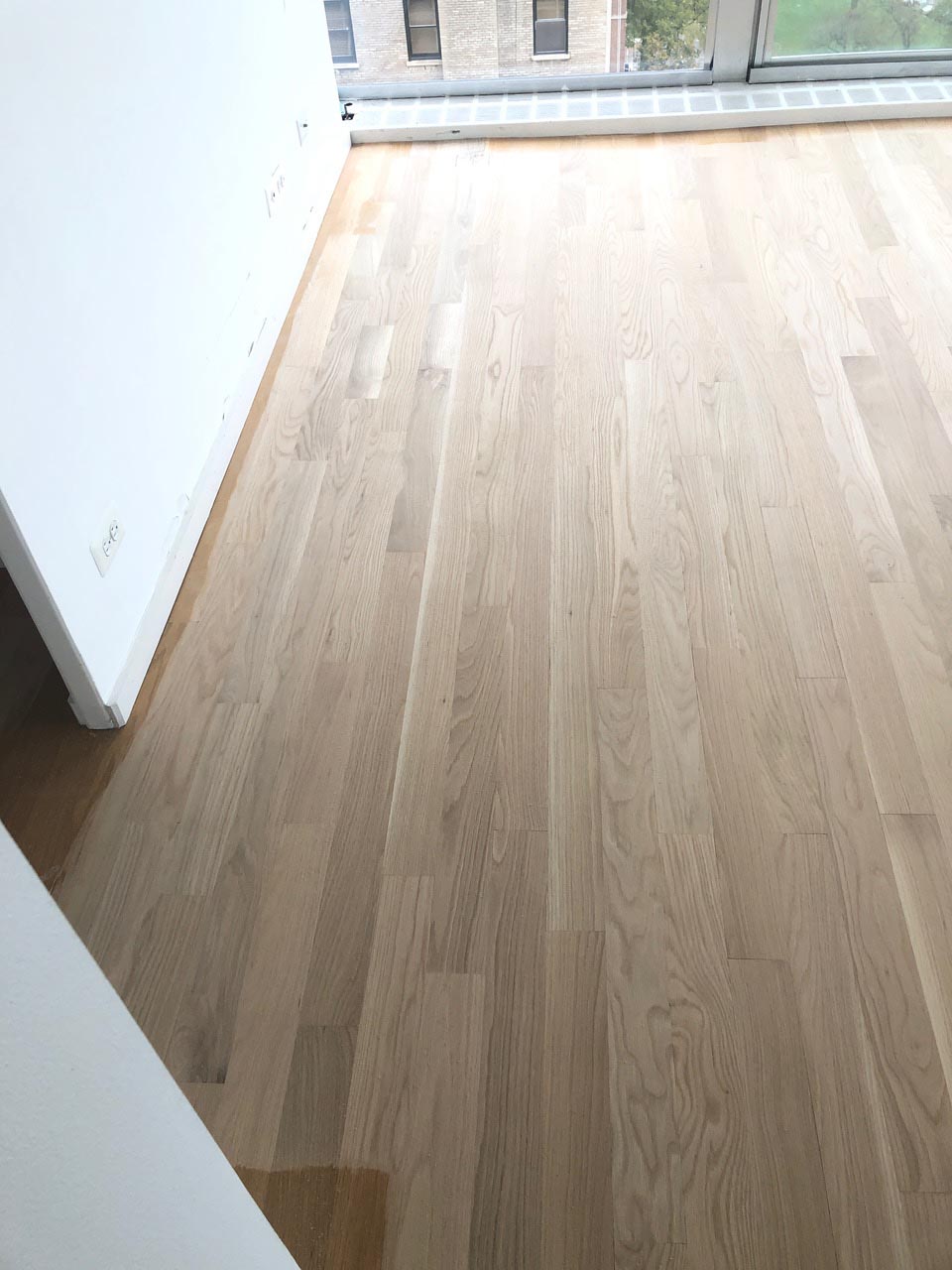 Red oak hardwood flooring during repair and refinishing by Midwest Hardwood Floors