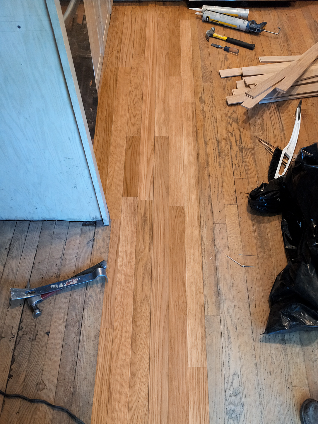 New oak hardwood flooring installed in repaired floor area in Chicago, IL by Midwest Hardwood Floors