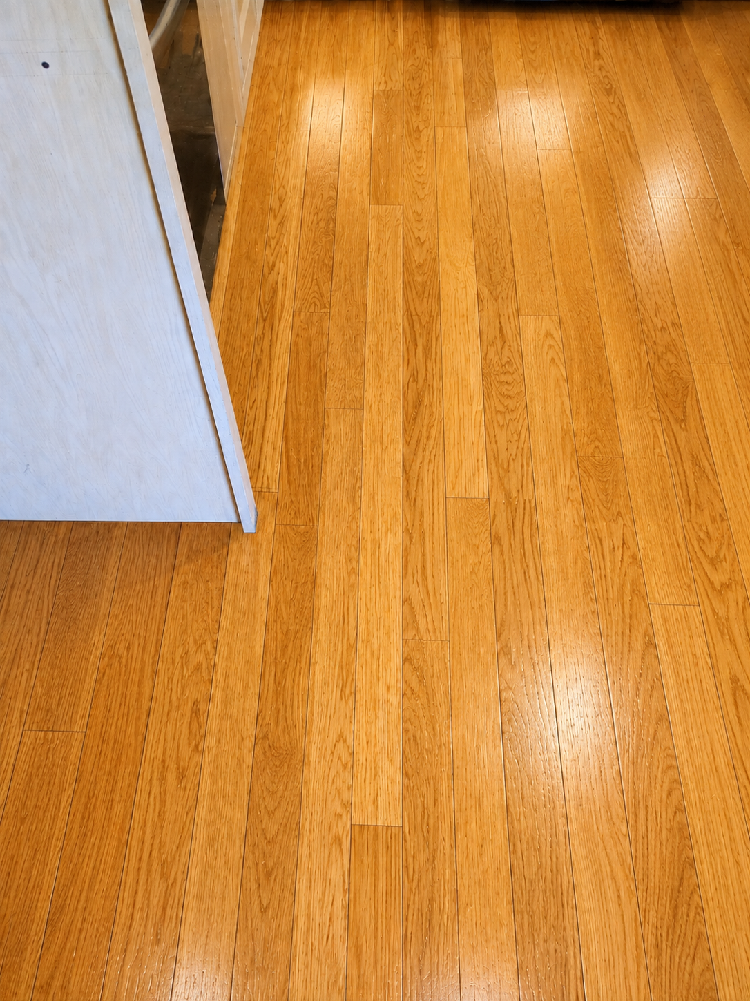 Repaired and refinished oak hardwood flooring with a natural honey finish in Chicago, IL by Midwest Hardwood Floors