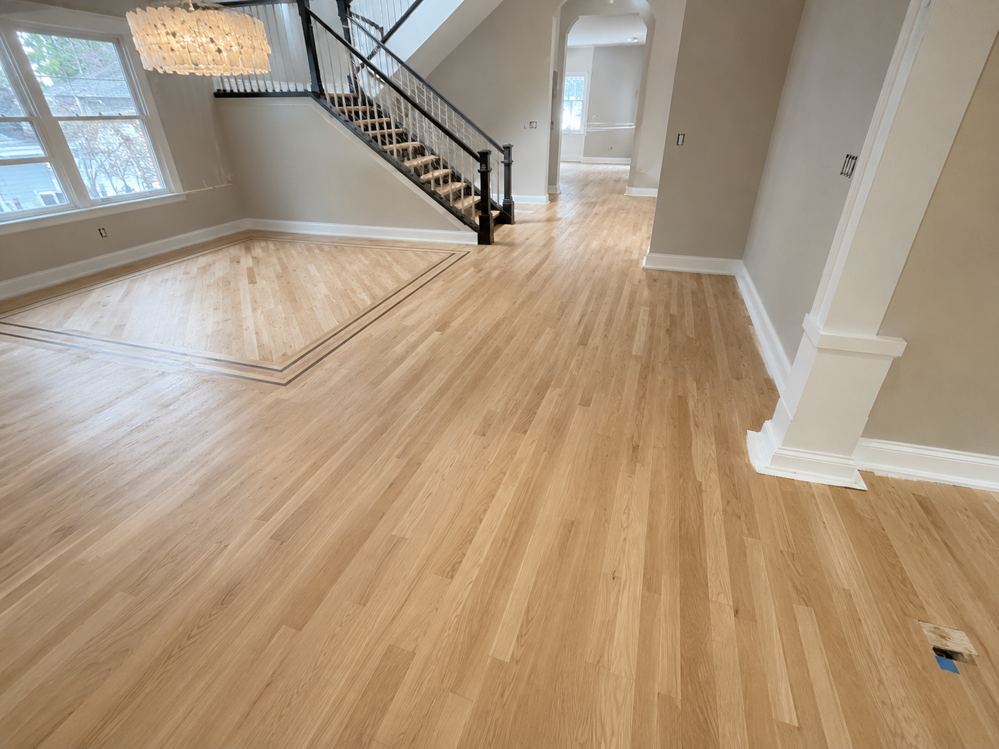 Unfinished hardwood floor prepared for refinishing in Winnetka, Illinois