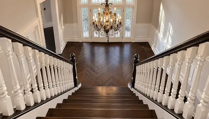 Refinished dark hardwood floors and staircase in Glencoe, IL