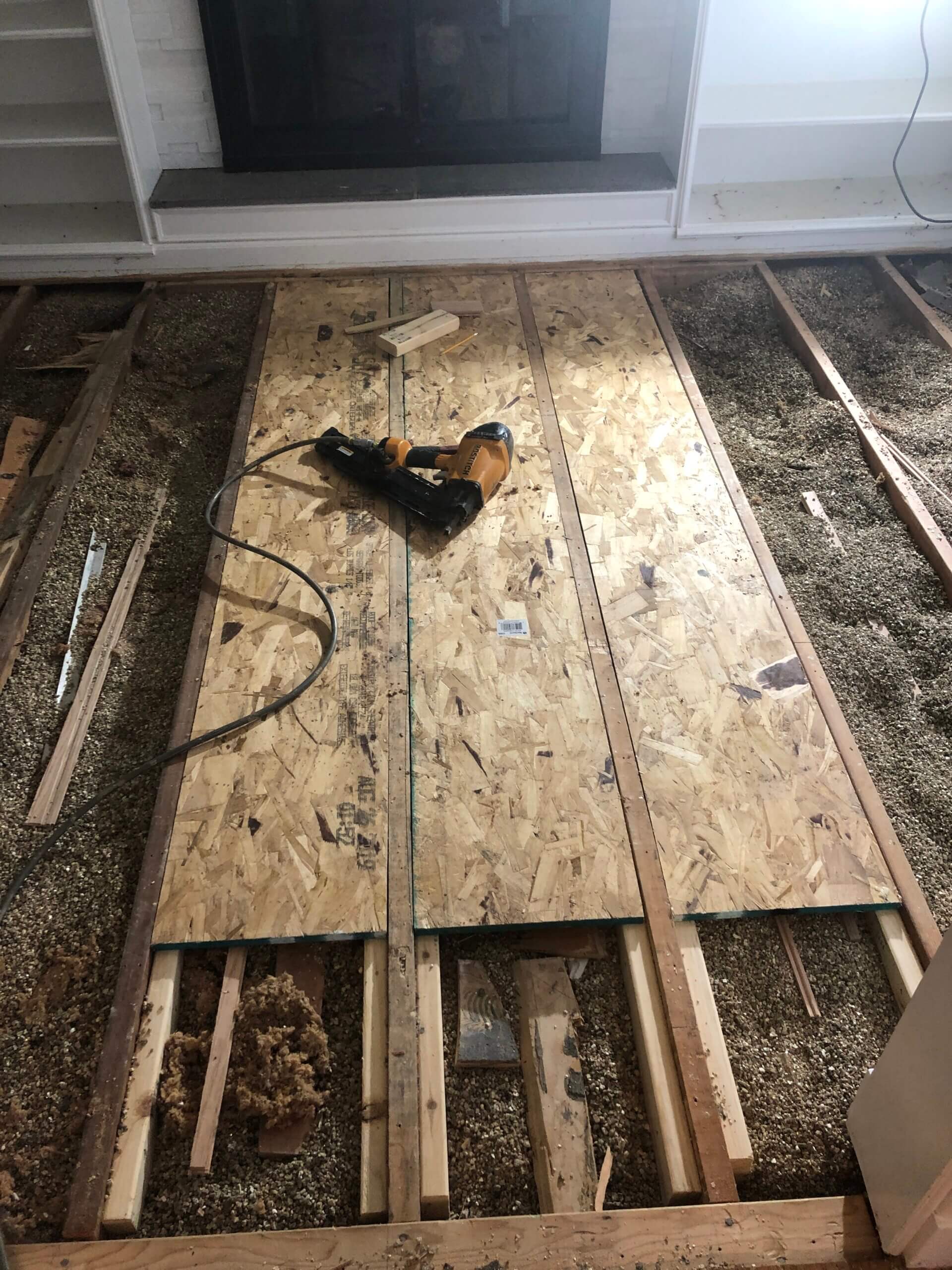 Subfloor reinforcement with new plywood over floor joists in Lake Forest, IL by Midwest Hardwood Floors