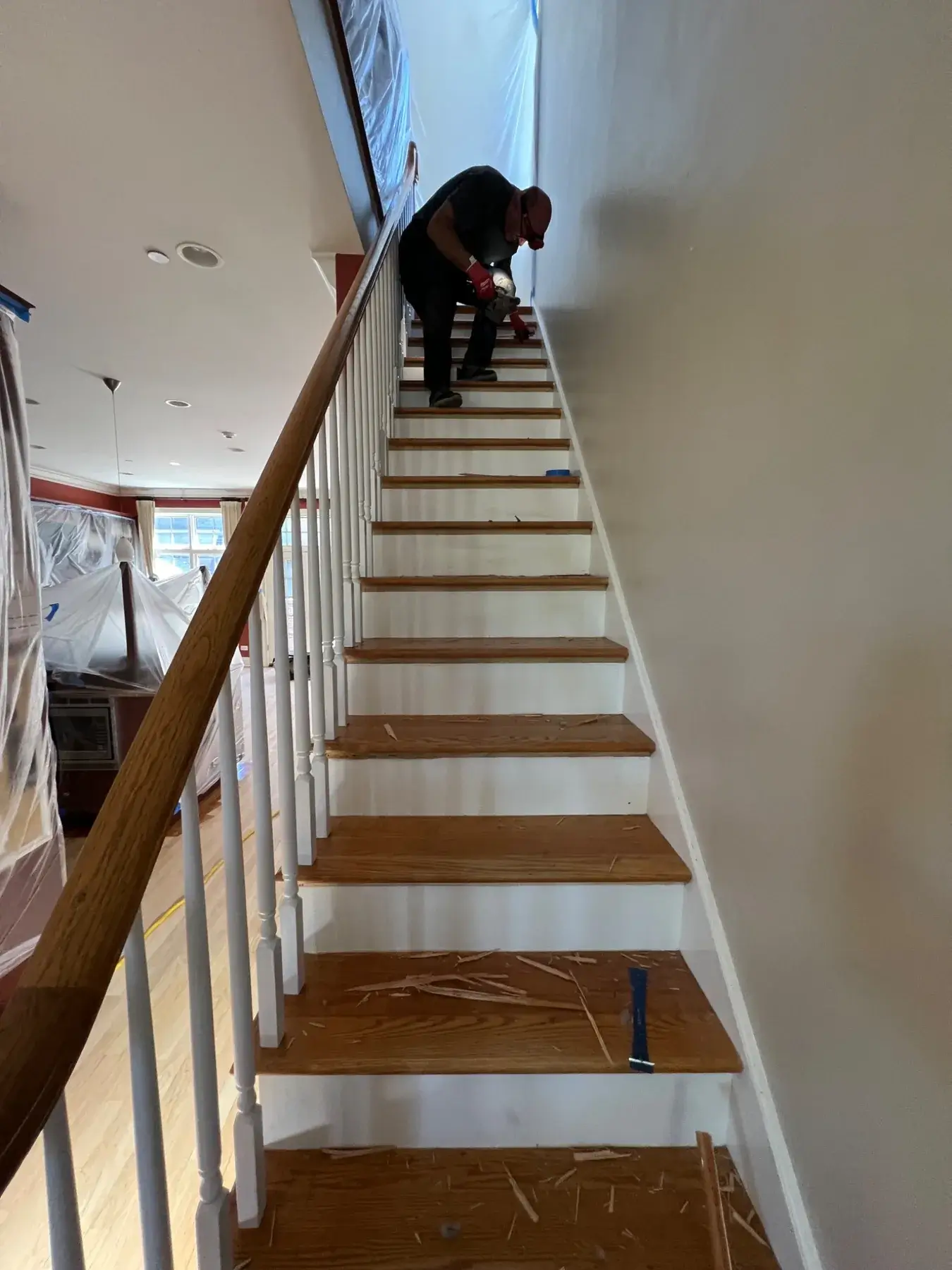 Carpet removal from hardwood staircase during Wilmette refinishing project