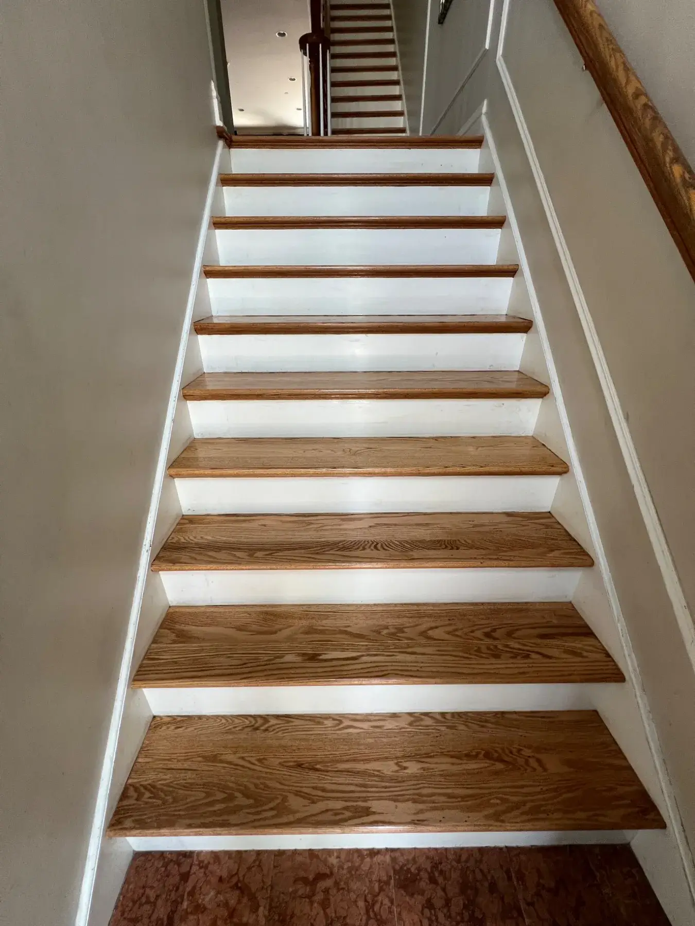 Exposed hardwood stair treads during refinishing in Wilmette, IL