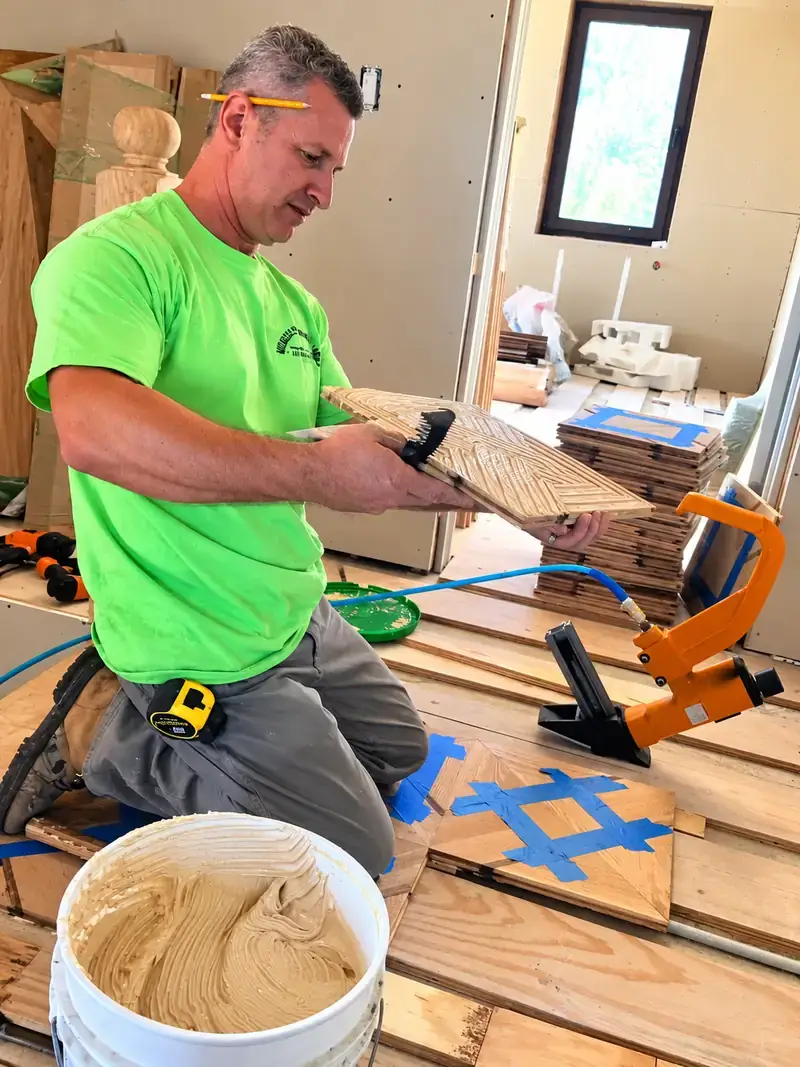 Marian, founder and owner of Midwest Hardwood Floors, working on a hardwood flooring installation
