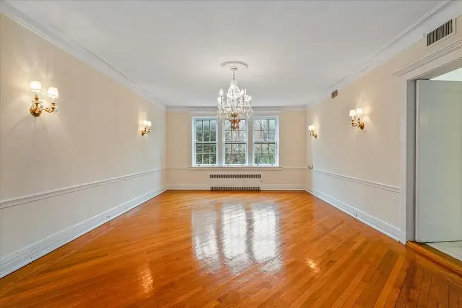 Newly refinished hardwood floor in an elegant empty room